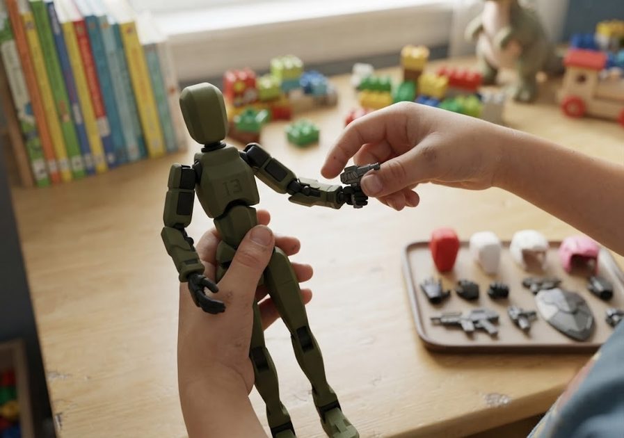 Kid's hands holding a Titan 13 action figure and changing accessories